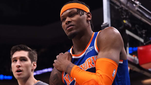 Mar 7, 2022; Sacramento, California, USA; New York Knicks forward Cam Reddish (21) leaves the court holding his right shoulder during the fourth quarter against the Sacramento Kings at Golden 1 Center.